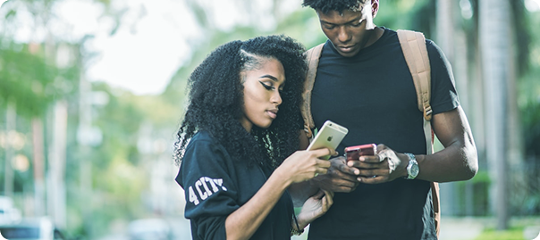 Couple using mobile phones for loan application